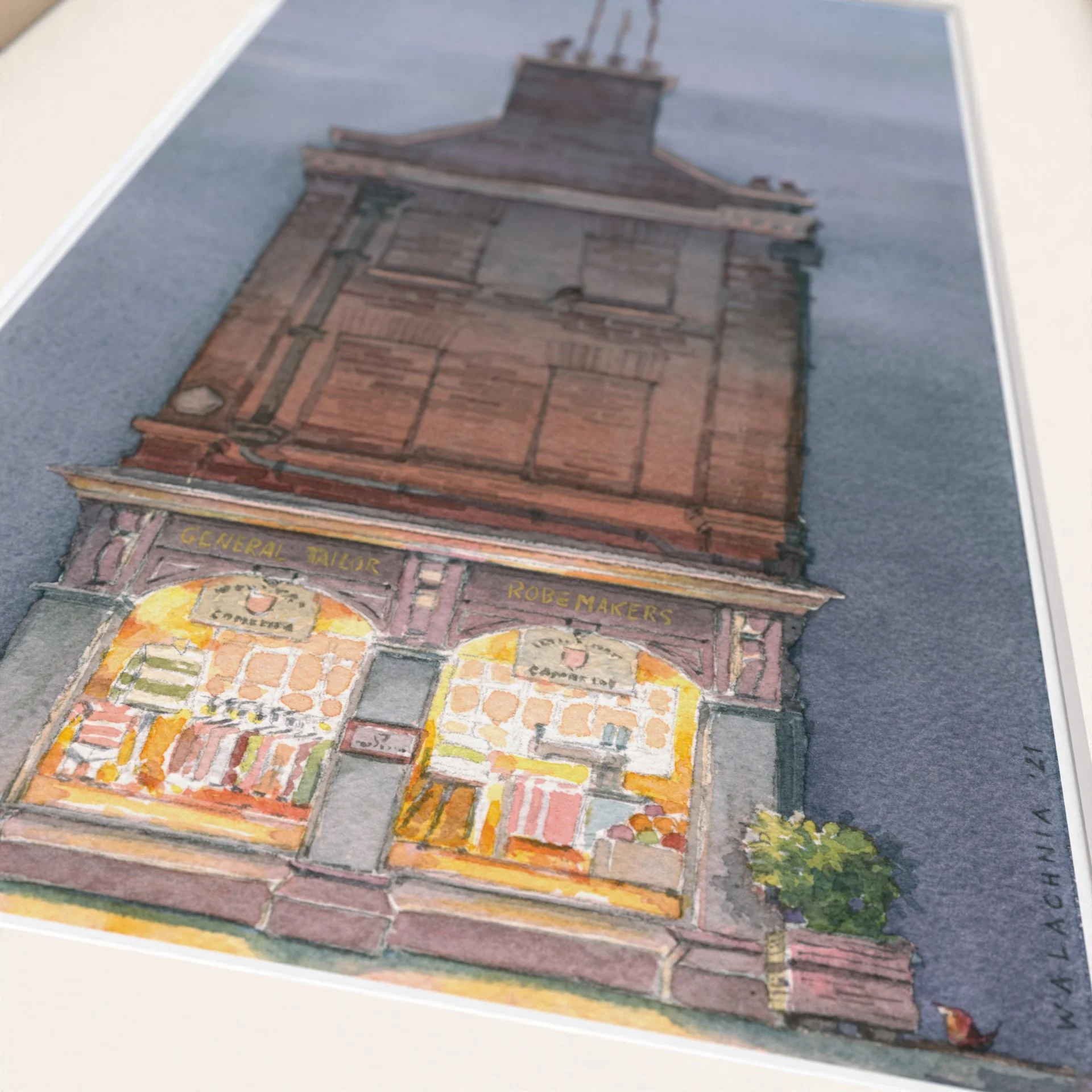 Watercolour painting showing King's Parade nr22 Cambridge University Store Ryder & Amies at Night